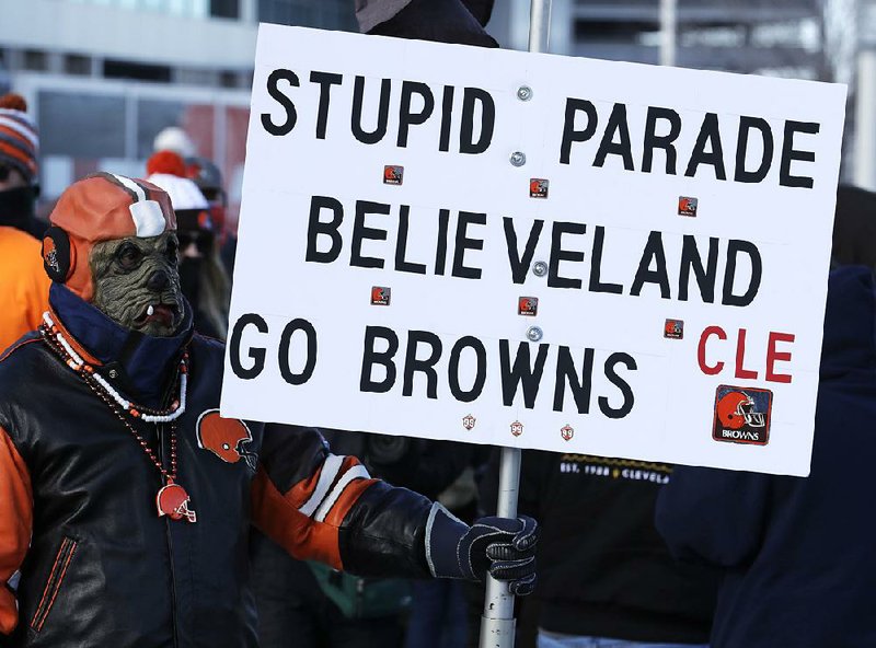 A Cleveland Browns fan watches the “Perfect Season” parade Saturday in Cleveland, which celebrated the Browns for becoming the second team in NFL history to lose 16 games in a season. The Browns joined the 2008 Detroit
Lions as the only teams to accomplish the feat.