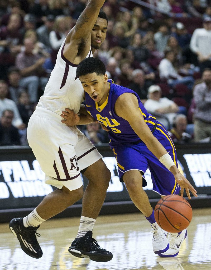LSU guard Tremont Waters (3) dribbles the ball around Texas A&M guard TJ Starks during the Tigers’ 69-68 victory over the No. 11 Aggies on Saturday in College Station, Texas. Waters hit an off-balance, last-second three-pointer to give the Tigers the victory.