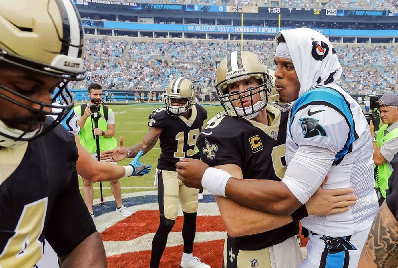 The Carolina Panthers Cam Newton (right) and New Orleans Saints Drew Brees embrace before their Sept. 24 matchup in Charlotte, N.C. The two will face off again today, this time at the Superdome in New Orleans.