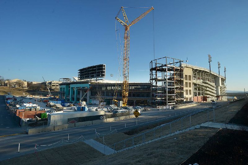 Construction crews work on the expansion project Wednesday at Reynolds Razorback Stadium in Fayetteville. The $160 million project will add suites, outdoor boxes and club seating, putting capacity at 76,000 seats. 
