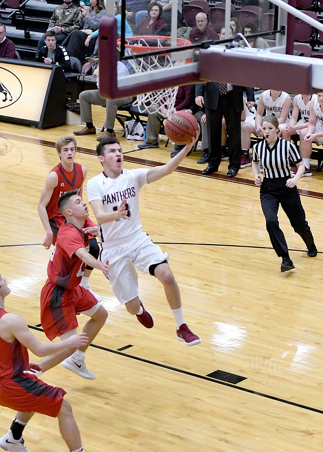 Bud Sullins/Special to Siloam Sunday Siloam Springs senior Diego Flores takes the ball to the basket during the second half of the Panthers' 64-59 victory against Farmington on Wednesday at Panther Activity Center.