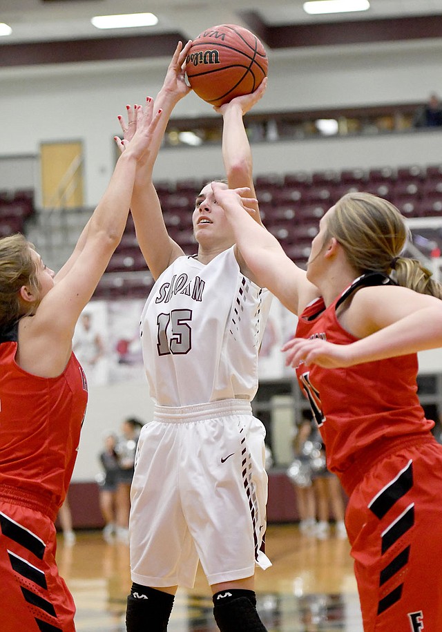 Bud Sullins/Special to Siloam Sunday Siloam Springs sophomore Shelby Johnson shoots over a pair of Farmington defenders during Wednesday's game at the Panther Activity Center.