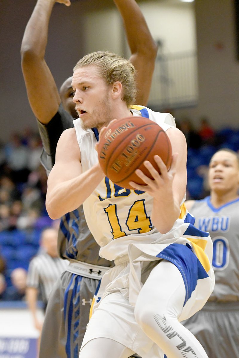 Bud Sullins/Special to Siloam Sunday John Brown University junior Jake Caudle looks to make a play Thursday night against Wayland Baptist at Bill George Arena.
