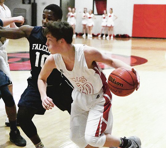 The Sentinel-Record/Rebekah Hedges TURN UP THE HEATON: Cutter Morning Star sophomore forward Colby Heaton dribbles past the 3-point line Friday during a a 67-48 loss at Eagle Fieldhouse to Maumelle Charter.