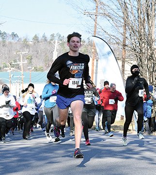 The Sentinel-Record/Rebekah Hedges RACE FOR BENEFIT: Noah Eskew, 17, of Jessieville, leads the third annual Jockey Jog on Saturday through 30-degree weather near Transportation Depot. The jog, held in Andrea LaPaglia Hamby's honor, raised over $12,000, with all proceeds benefiting Arkansas Children's Hospital.