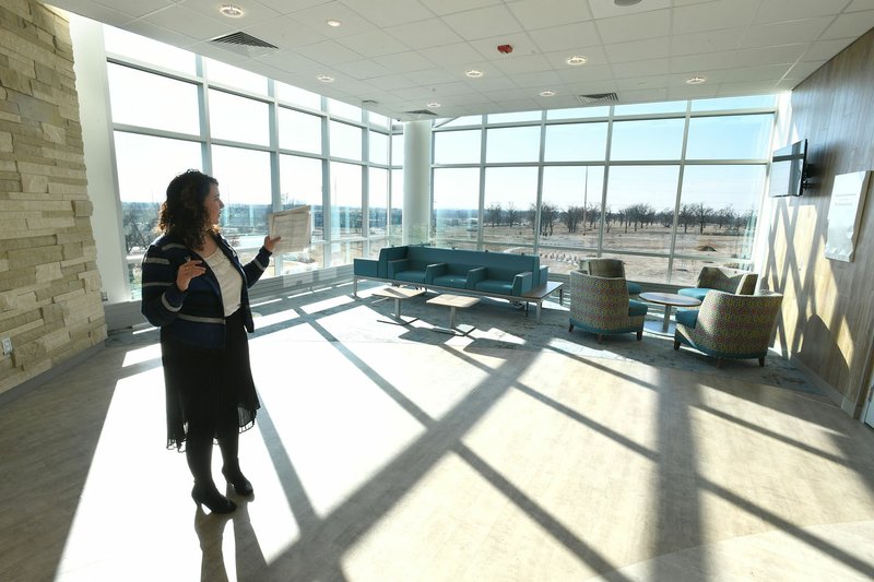 Hilary Demillo, spokeswoman for Arkansas Children's Hospital Northwest, shows off the hospital's natural light during a tour Saturday in Springdale. The 37-acre site also includes outdoor paths and rooms for families. "We're not caring for one patient, we're caring for the family," DeMillo said.