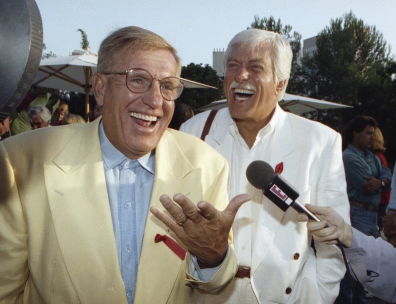FILE - In this Aug. 25, 1992 file photo, Jerry Van Dyke, left, and his brother, Dick, laugh during a party in Los Angeles. Manager said Saturday, Jan. 6, 2018, that Jerry Van Dyke, 'Coach' star and younger brother of comedian Dick Van Dyke, has died in Arkansas at 86. Manager, John Castonia, said Van Dyke died Friday at his ranch in Hot Spring County. His wife, Shirley Ann Jones, was by his side. (AP Photo/Chris Martinez, File)