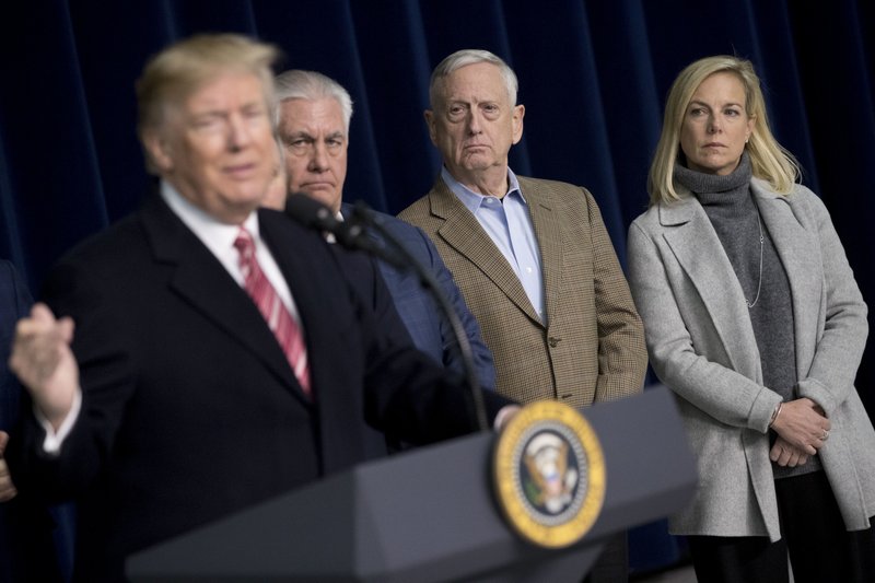 From left, President Donald Trump, accompanied by Secretary of State Rex Tillerson, Defense Secretary Jim Mattis, and Secretary of Homeland Security Kirstjen Nielsen, speaks to members of the media after participating in a Congressional Republican Leadership Retreat at Camp David, Md., Saturday, Jan. 6, 2018. (AP Photo/Andrew Harnik)