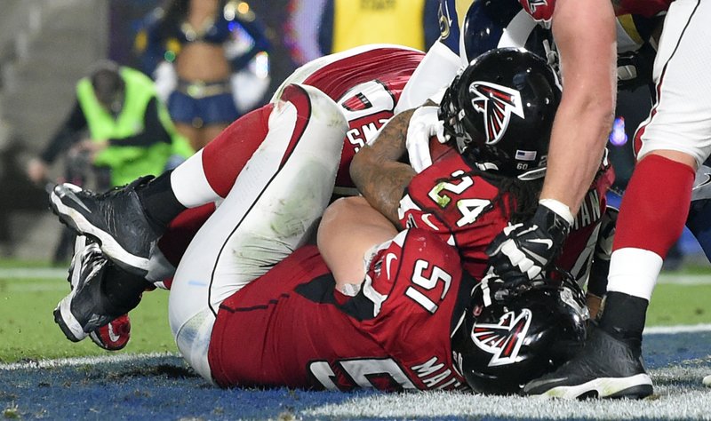 Atlanta Falcons running back Devonta Freeman (24) scores against the Los Angeles Rams during the first half of an NFL football wild-card playoff game Saturday, Jan. 6, 2018, in Los Angeles. (AP Photo/Mark J. Terrill)