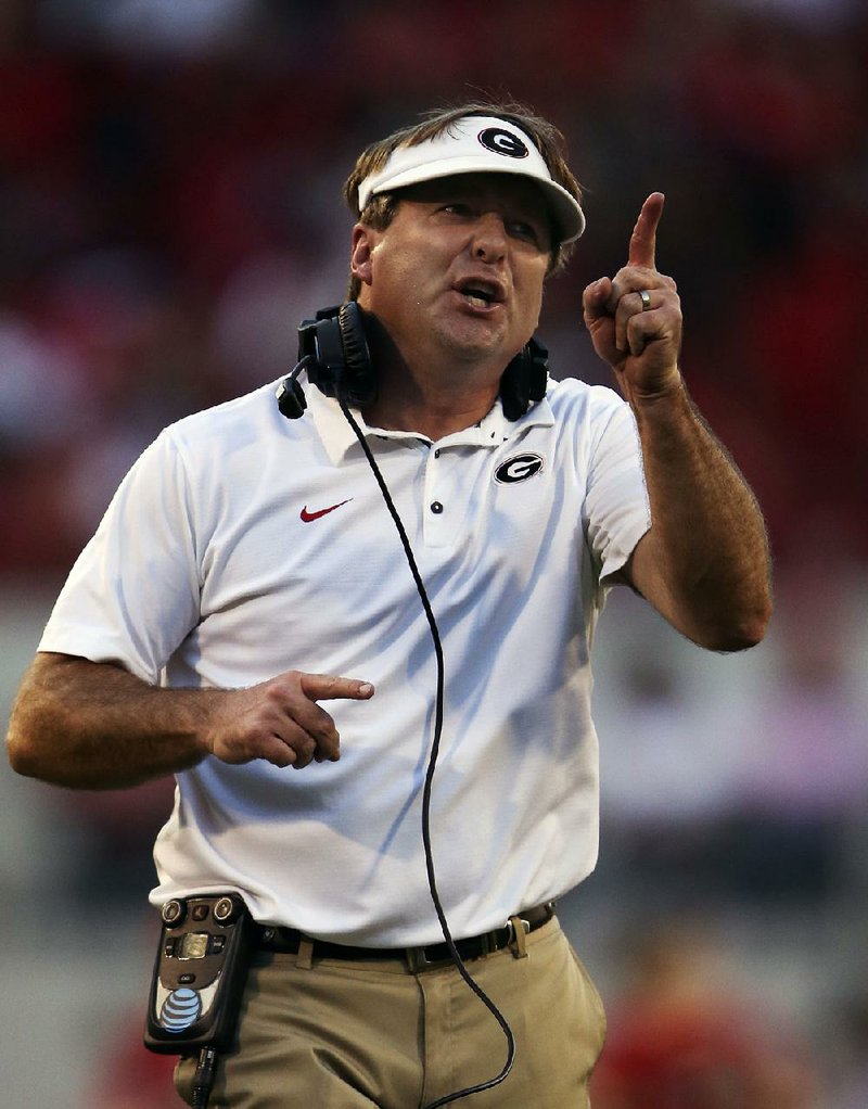 In this Nov. 4, 2017, file photo, Georgia head coach Kirby Smart yells at one of his players during the second half of an NCAA college football game against South Carolina, in Athens, Ga. 