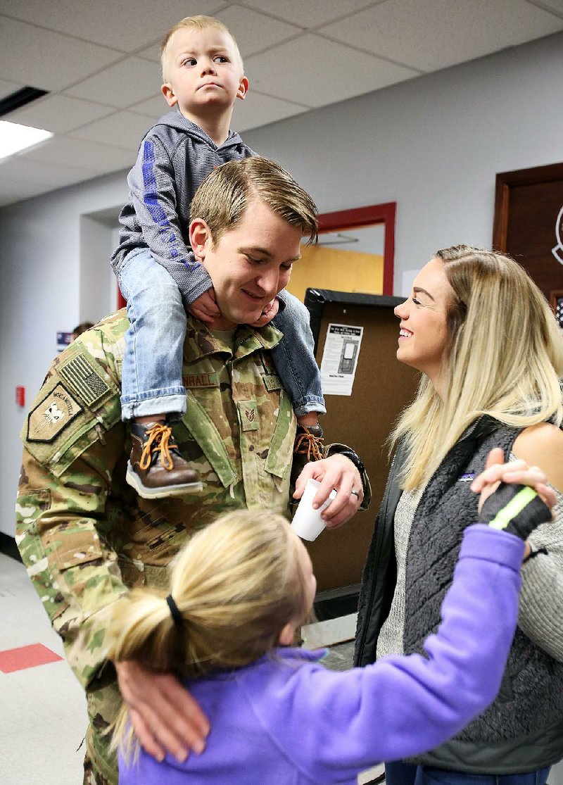 Staff Sgt. Shane Mendenhall says goodbye to his family, son Hunter (top), 3; daughter Myleigh (bottom), 7; and wife, Amy, before deploying Sunday morning at Little Rock Air Force Base in Jacksonville. Mendenhall was part of a group of 100 airmen from the base who were deploying to Afghanistan. More photos are available at arkansasonline.com/galleries.
