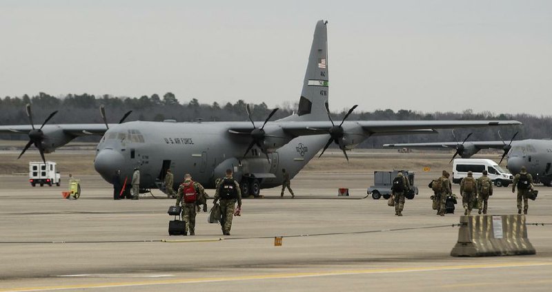 FILE — Airmen walk across the flight line to their C-130J on Jan. 7, 2018, at Little Rock Air Force Base in Jacksonville. 