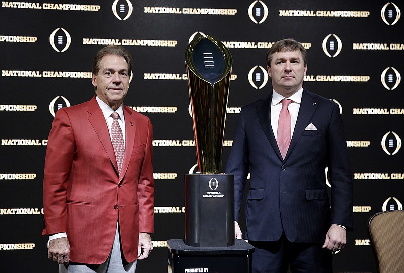 Alabama head coach Nick Saban, left, and Georgia head coach Kirby Smart pose with the NCAA college football championship trophy at a press conference in Atlanta, Sunday, Jan. 7, 2018. Georgia and Alabama will be playing for the championship on Monday, Jan. 8. (AP Photo/David Goldman) Alabama head coach Nick Saban, left, and Georgia head coach Kirby Smart pose with the NCAA college football championship trophy at a press conference in Atlanta, Sunday, Jan. 7, 2018. Georgia and Alabama will be playing for the championship on Monday, Jan. 8. (AP Photo/David Goldman)