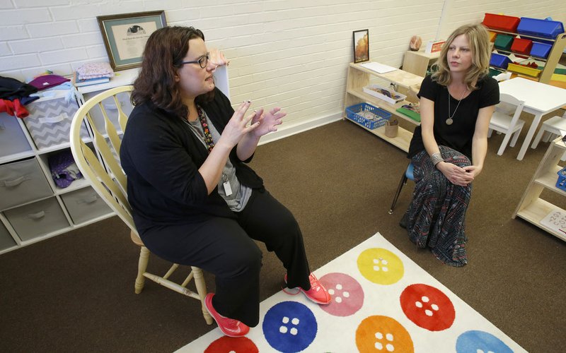 Candice Sisemore (left), owner and lead preschool teacher, and Melissa Graham, director, speak Thursday in the preschool classroom at Teeny Tiny Preschool in Fayetteville. Classes return today from the Christmas break at the school that opened in October. The program for children 18 months to 5 years old moved into the former Willow Heights community building at 10 S. Willow Ave.
