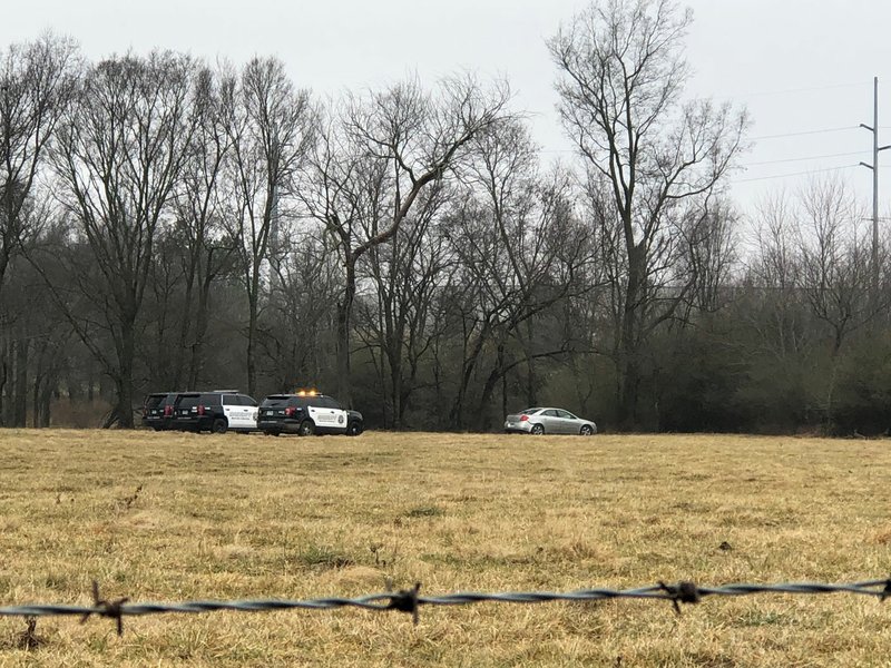 NWA Democrat-Gazette/MELISSA GUTE Benton County Sheriff deputies work the scene off South Morning Star Road in this morning where police say a suspect, Cody Krawetzke, fled on foot.