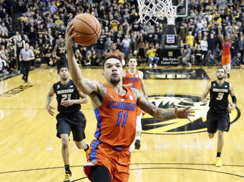 Florida's Chris Chiozza (11) heads to the basket to score the game-winning shot as time expires in an NCAA college basketball game against Missouri, Saturday, Jan. 6, 2018, in Columbia, Mo. Florida won 77-75. (AP Photo/Jeff Roberson)