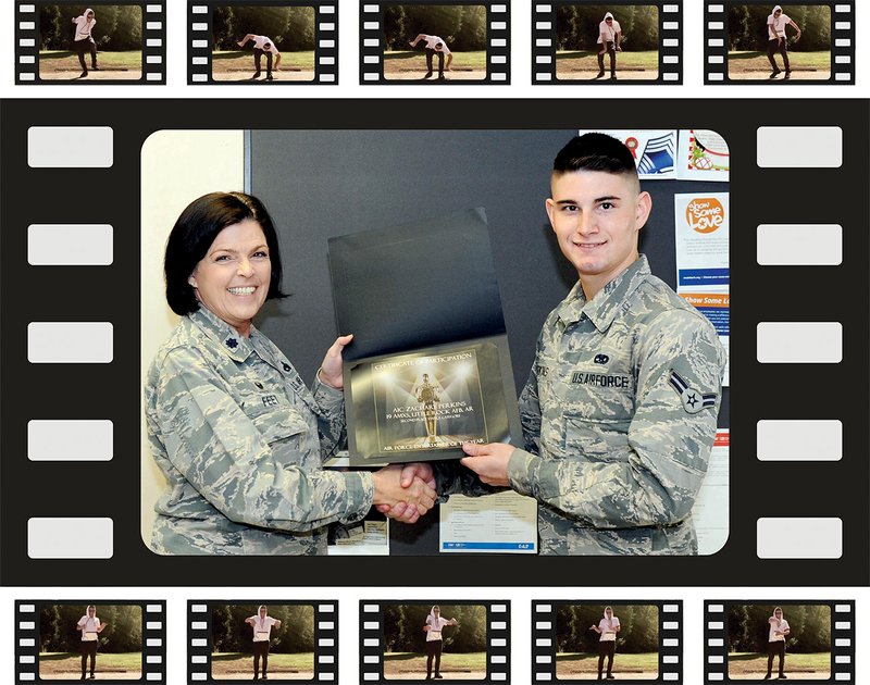 Lt. Col. Tiffany Feet, 19th Aircraft Maintenance Squadron commander, presents Airman 1st Class Zachary Perkins, 19th Aircraft Maintenance Squadron crew chief, a certificate for achieving runner-up status in the 2017 Air Force Entertainer of the Year, Group 1, Nonvocal category, on Dec. 13 at the Little Rock Air Force Base. Perkins, a four-year animation dancer, danced to “Voice of Reason,” by Haywire, in the online video talent contest sponsored by the Air Force Services Activity. 