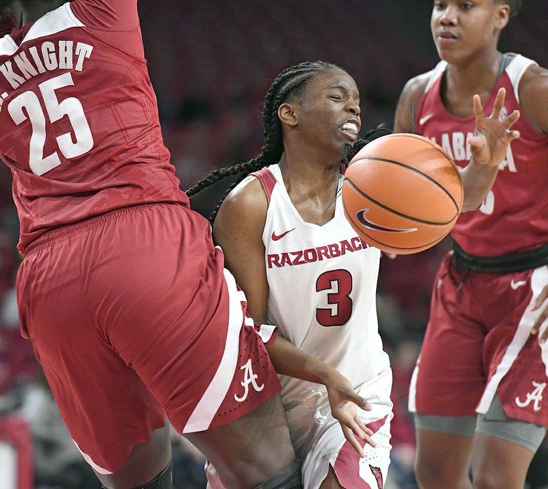 NWA Democrat-Gazette/J.T. Wampler BREAKING DOWN: Arkansas' Malica Monk (3) gets her shot broken up by Alabama's Ashley Knight (25) and Shaquera Wade (23) Sunday. Arkansas lost 83-76.