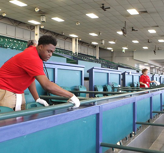 The Sentinel-Record/Richard Rasmussen TIME TO SHINE: Oaklawn Park maintenance employee Dequan Haywood cleans a box in the grandstand at the facility Monday. Fifty new box seats were added after the 2017 meet wrapped up.