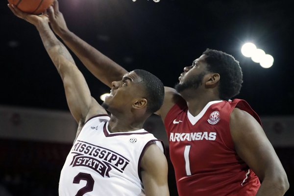 Mississippi State guard Eli Wright (2) attempts a layup basket past Arkansas forward Trey Thompson (1) during the first half of their NCAA college basketball game in Starkville, Miss., Tuesday, Jan. 2, 2018. (AP Photo by Rogelio V. Solis)

