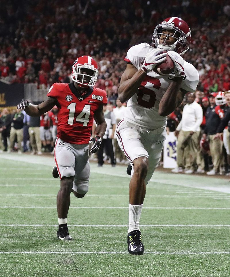 Alabama wide receiver DeVonta Smith catches a touchdown pass past Georgia defensive back Malkom Parrish in overtime to lift the Crimson Tide to a 26-23 victory over the Bulldogs in the College Football Playoff national championship Monday in Atlanta.