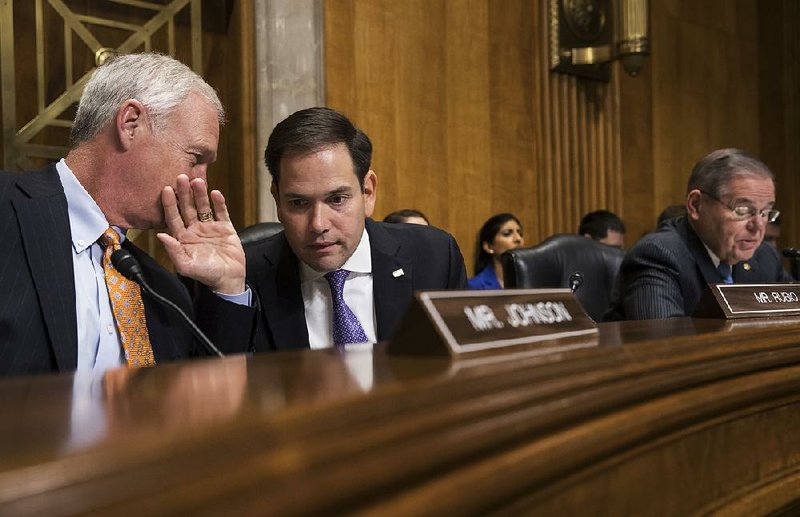 Sen. Marco Rubio, R-Fla. (right), confers Tuesday with Sen. Ron Johnson, R-Wis., as the Senate Foreign Relations Subcommittee on the Western Hemisphere discusses suspected attacks on American diplomats in Havana. 
