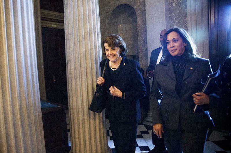 Democratic Sens. Diane Feinstein (left) and Kamala Harris of California walk through the U.S. Capitol on Tuesday. Feinstein on Tuesday released the transcript of an interview by Senate Judiciary Committee investigators with Glenn Simpson, the head of the research firm that compiled a dossier on then-candidate Donald Trump in 2016. 