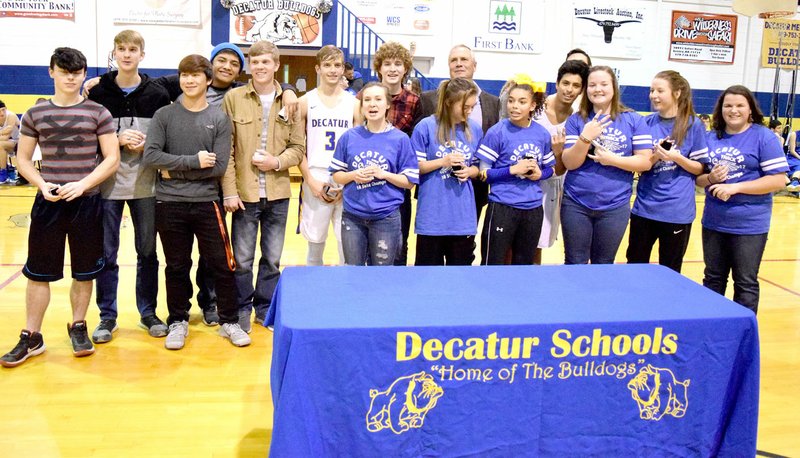 Westside Eagle Observer/MIKE ECKELS Members of 2013, 2015, 2016 and 2017 Decatur track teams were presented with state championship rings during a ceremony at Peterson Gym in Decatur Jan. 5. Members receiving the rings included Johnny Brandon (left), Bracy Owens, Leng Lee, Mark Guadarrama (2015, 2016) Even Owens (2013), Taylor Haisman, Meagan Smith, Ryan Shaffer, Destiny Mejia, Coach Shane Holland, Desi Meek, Jimmy Mendoza, Cameron Shaffer, Paige Vann, Paige Barrett and Cayden Bingham (hidden behind Mendoza).