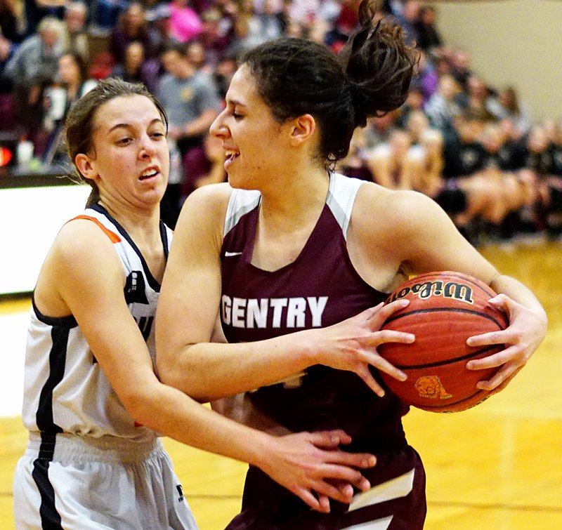 Westside Eagle Observer/RANDY MOLL Gentry's Hannah Boss (right) grabs the rebound away from Gravette's Shylee Morrison during play on Friday night in Gravette.