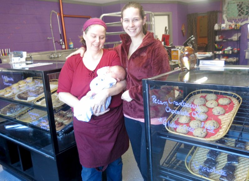 Westside Eagle Observer/SUSAN HOLLAND Maria Dolberry, her daughter Deborah Barber and granddaughter Lilith posed recently beside the display cases filled with baked goods at their Dessert Diversity shop in Sulphur Springs. The business is open 6:30 a.m. to 6:30 p.m. Mondays, Tuesdays, Thursdays and Fridays and 8 a.m. to 3 p.m. Saturdays and Sundays. Telephone number for the bakery is 479-298-1233.