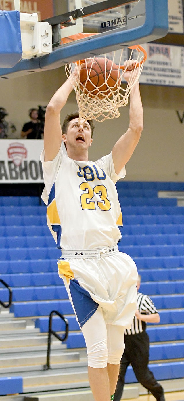Bud Sullins/Special to the Herald-Leader John Brown freshman Rokas Grabliauskas goes up for a two-handed dunk during the first half of Saturday's game against Panhandle State.