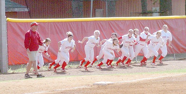 MARK HUMPHREY/ENTERPRISE-LEADER Farmington softball coach Randy Osnes has the team staying flexible with short sprints in between innings. On April 1, Osnes recorded his 500th career victory as head coach with a 5-4 win at Conway. Osnes has an overall career record of 511-146 with three state championships on his resume.