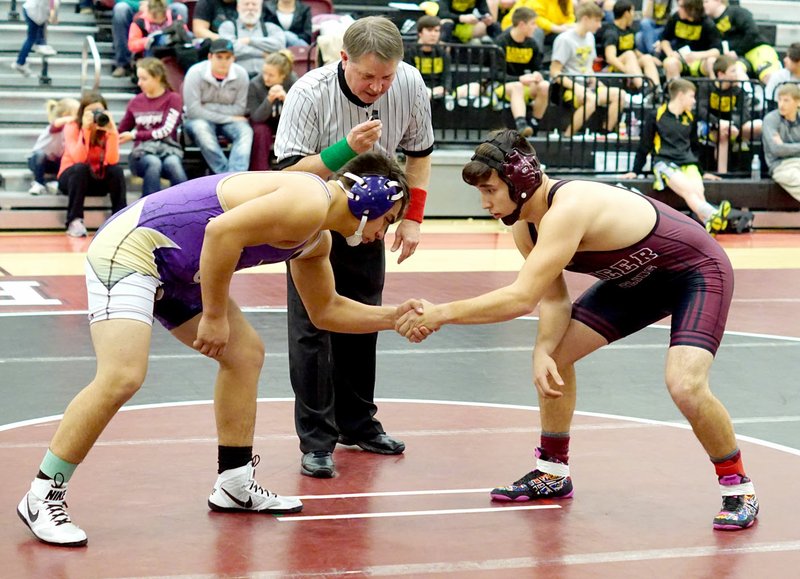 Westside Eagle Observer/RANDY MOLL Matthew Nance (right) shakes hands with his Berryville opponent at the start of his match during a wrestling tournament in Gentry on Thursday.