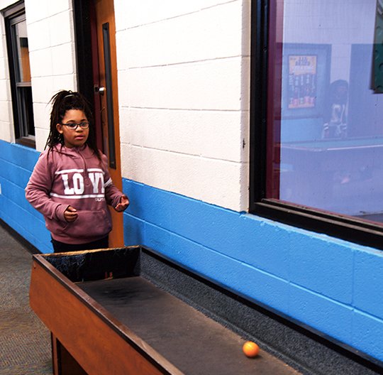 The Sentinel-Record/Grace Brown - My'teshja Tash, 10, of Hot Springs plays carpet ball at the Hot Springs Boys and Girls Club on Tuesday, January 9, 2018. 