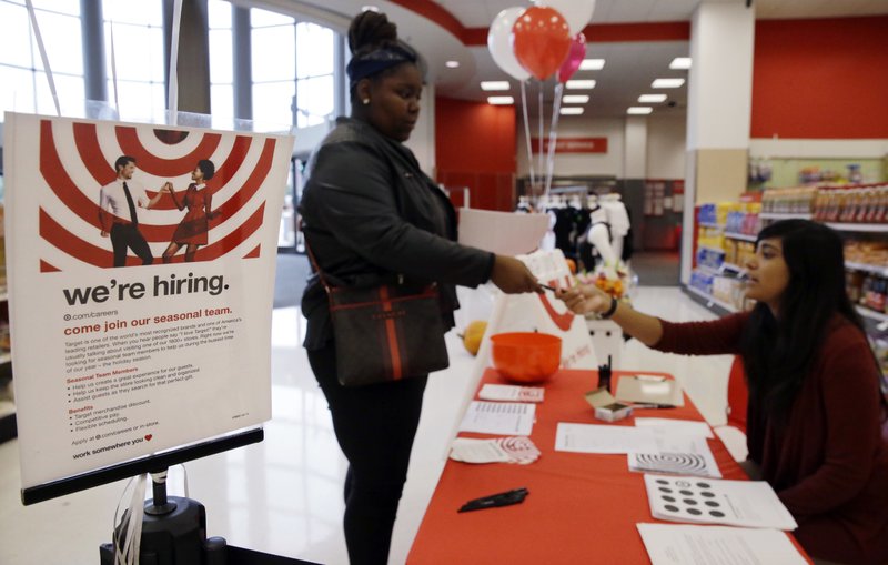In this Sunday, Oct. 15, 2017, photo, Target human resources representative Brenda, right, talks with a job seeker at a Target store in Chicago. (AP Photo/Nam Y. Huh)