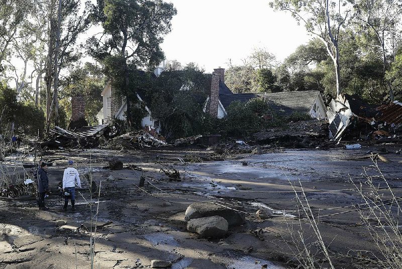 Mud and debris surround a destroyed home Wednesday in Montecito, Calif., after Tuesday’s deadly mudslides. Seventeen people were confirmed dead as rescue crews searched for more than a dozen people who were missing.  