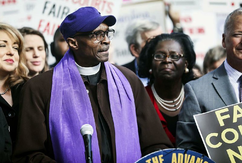 The Rev. Anthony Spearman, North Carolina's NCAAP president, speaks Wednesday about a federal court's decision to strike down North Carolina's congressional map. 