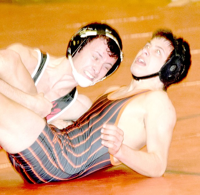 RICK PECK/SPECIAL TO MCDONALD COUNTY PRESS McDonald County's Jakob Gerow has Michael Taylor of Republic on his back on the way to claiming a 9-1 decision during the Tigers' 41-37 win in a dual on Jan. 4 at MCHS.