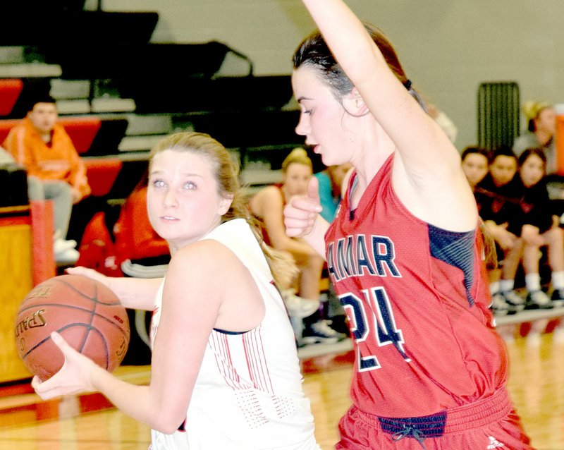 RICK PECK/SPECIAL TO MCDONALD COUNTY PRESS McDonald County's Megan Mills looks to score while being defended by Lamar's Lauren Compton during the Lady Mustangs' 44-37 loss on Jan. 4 at MCHS.