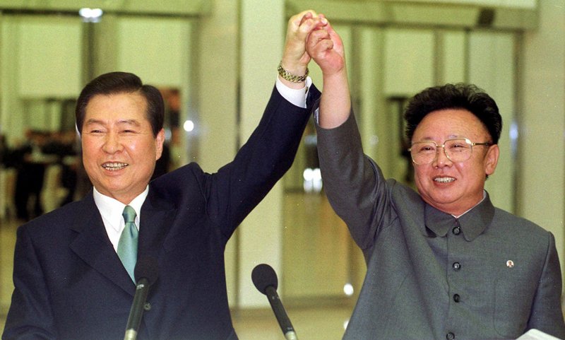 FILE -- In this June 14, 2000, file photo, South Korean President Kim Dae-jung, left, and North Korean leader Kim Jong Il raise their arms together before signing a joint declaration during a summit in Pyongyang, North Korea. Leaders of the two Koreas have met only twice for summit talks during the last 70 years, and talks of a third summit flared again Wednesday, when the south's current liberal President Moon Jae-in said he's willing to meet North Korean leader Kim Jong Un if the success of the meeting is guaranteed. (Yonhap Pool Photo via AP, File)