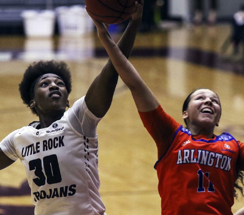 UALR’s Raeyana DeGray (left) fights for a rebound with Texas-Arlington’s Shelby Richards during Thursday night’s game at the Jack Stephens Center in Little Rock.