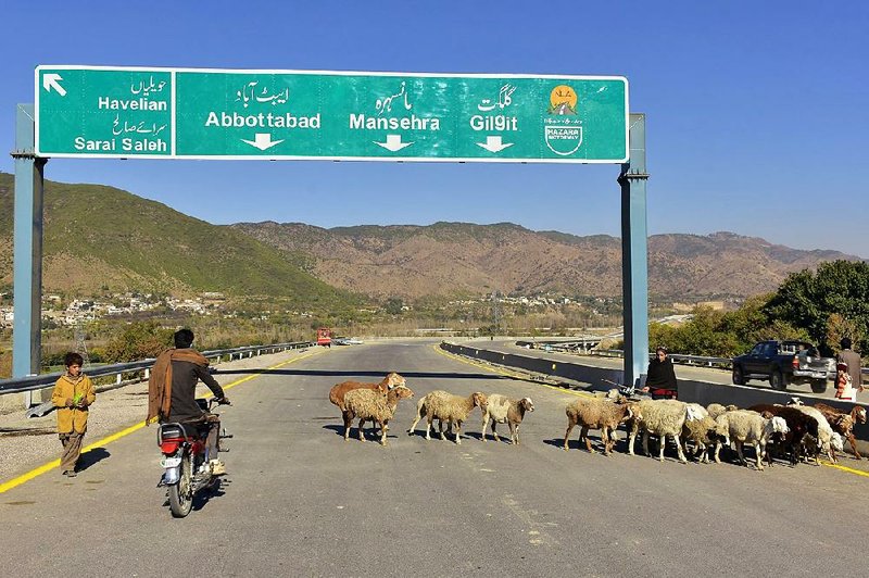 A Pakistani motorcyclist drives on a newly built Pakistan China Silk Road in Haripur in December. The road was part of a Chinese joint infrastructure project with Pakistan.