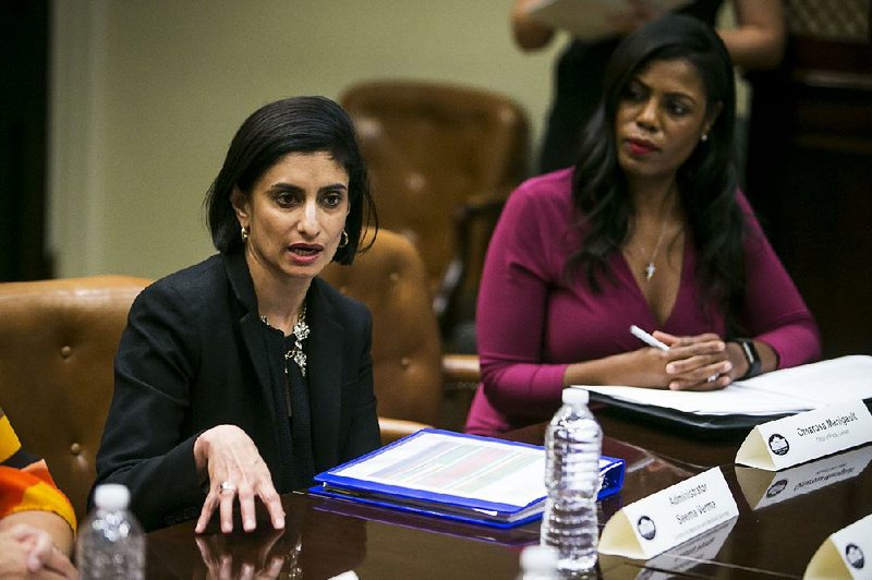 Seema Verma, left, administrator of the Centers for Medicare and Medicaid Services, is shown with former White House aide Omarosa Manigault during a Health and Human Services listening session on the Affordable Care Act, in the Roosevelt Room of the White House, June 21, 2017. 