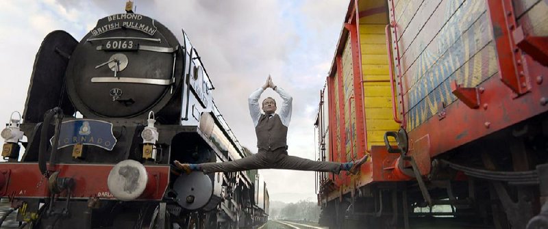 Risk analyst dad Henry Brown (Hugh Bonneville) dabbles in yoga in Paul King’s Paddington 2.