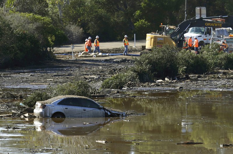AP Photo/MARCIO JOSE SANCHEZ A car sits stranded in flooded water in Montecito, Calif., Wednesday, Jan. 10, 2018. Dozens of homes were swept away or heavily damaged and several people were killed Tuesday as downpours sent mud and boulders roaring down hills stripped of vegetation by a gigantic wildfire that raged in Southern California last month.