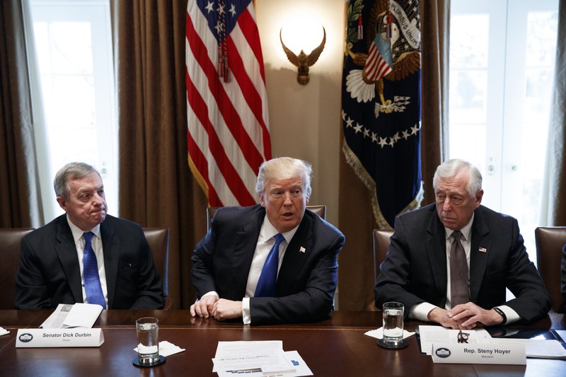 In this Jan. 9, 2017, photo, Sen. Dick Durbin, D-Ill., left, and Rep. Steny Hoyer, D-Md. listen as President Donald Trump speaks during a meeting with lawmakers on immigration policy in the Cabinet Room of the White House in Washington. Bargainers seeking a bipartisan immigration accord planned talks as soon as Wednesday as President Donald Trump and leading lawmakers sought to parlay an extraordinary White House meeting into momentum for resolving a politically blistering issue.