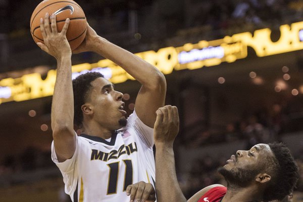Missouri's Jontay Porter, left, shoots over Georgia's Yante Maten during the second half of an NCAA college basketball game Wednesday, Jan. 10, 2018, in Columbia, Mo. Missouri won 68-56. (AP Photo/L.G. Patterson)


