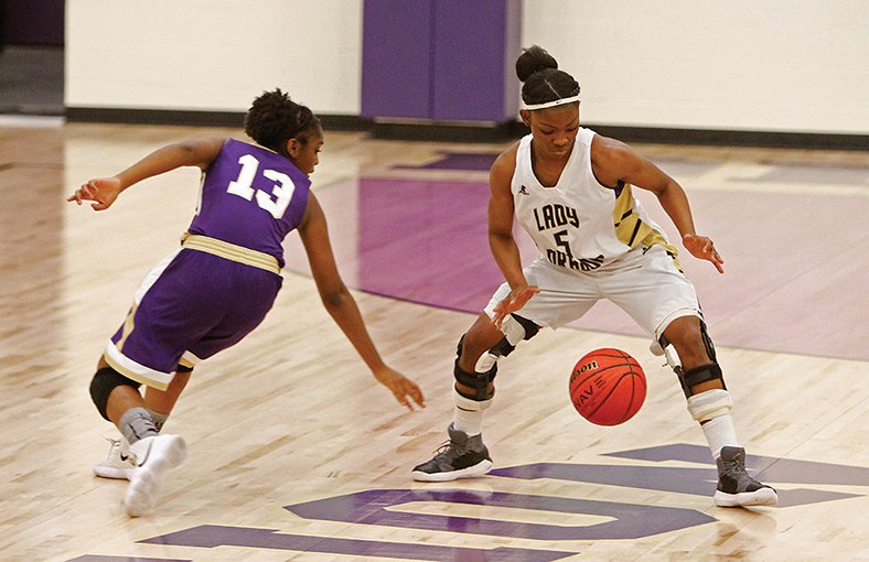 Terrance Armstard/News-Times Junction City’s Taykeetria Rogers (5) and England’s Hannah Phillips (13) go after the ball during the first half of their game in Junction City on Thursday night.