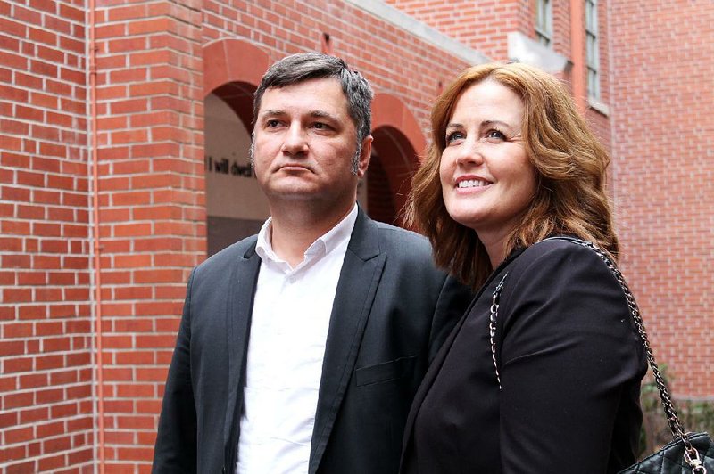 Jessica Morris-Ivanova  (right), with  husband  Ivaylo  Ivanov  are shown  in  the  courtyard  of  Little  Rock’s  First  United  Methodist Church on Monday. The  couple  co-pastor United Methodist Church of Shumen in northeastern Bulgaria.