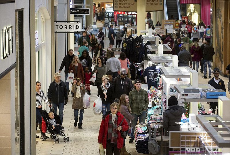 Shoppers look for post-Christmas discounts at Valley View Mall in Roanoke, Va. The National Retail Federation said Friday that holiday sales reached $691.9 billion as shoppers stepped up their spending in the brightening economy. 